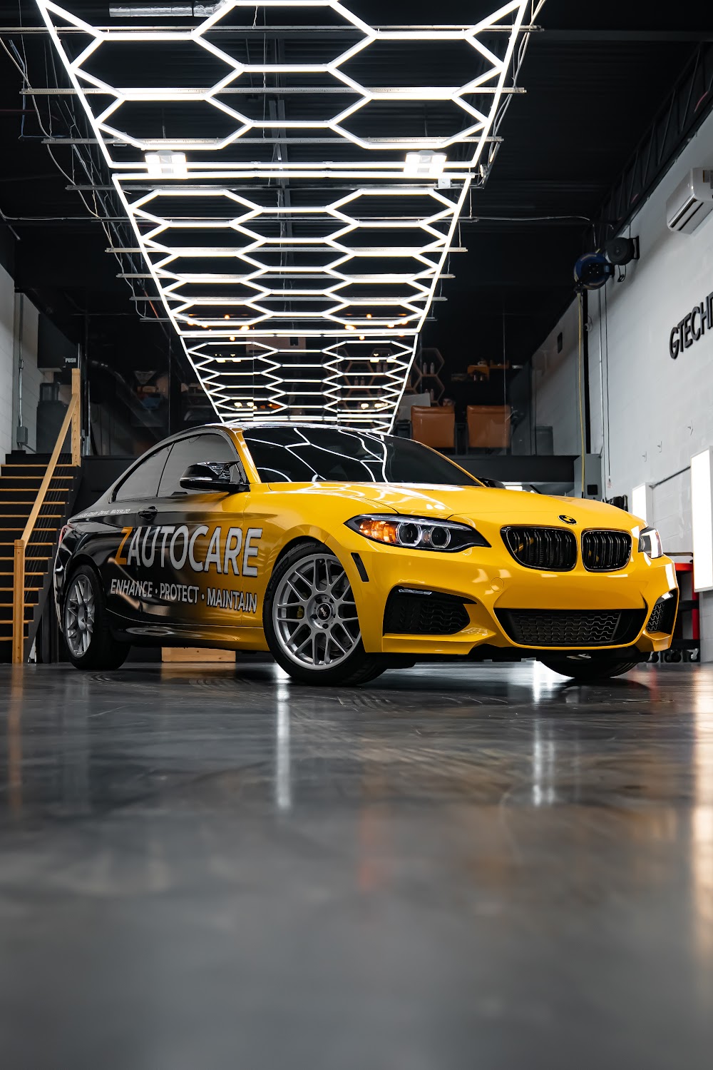ZAutoCare's branded BMW beneath the hexagon light tunnel