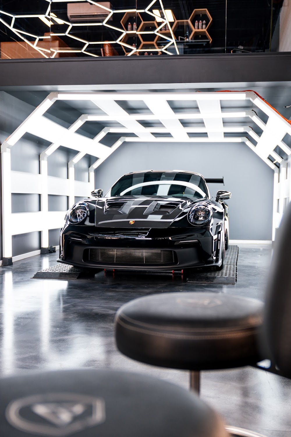 Black and red 992 GT3 RS in ZAutoCare's hexagon studio