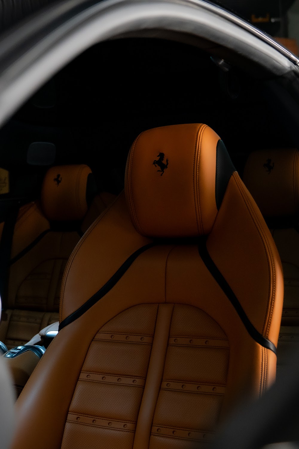 Tan leather Ferrari interior with embossed Cavallino headrest