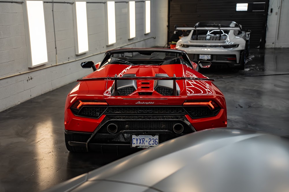 Red Huracan Performante Spyder with a GT3 RS in the background