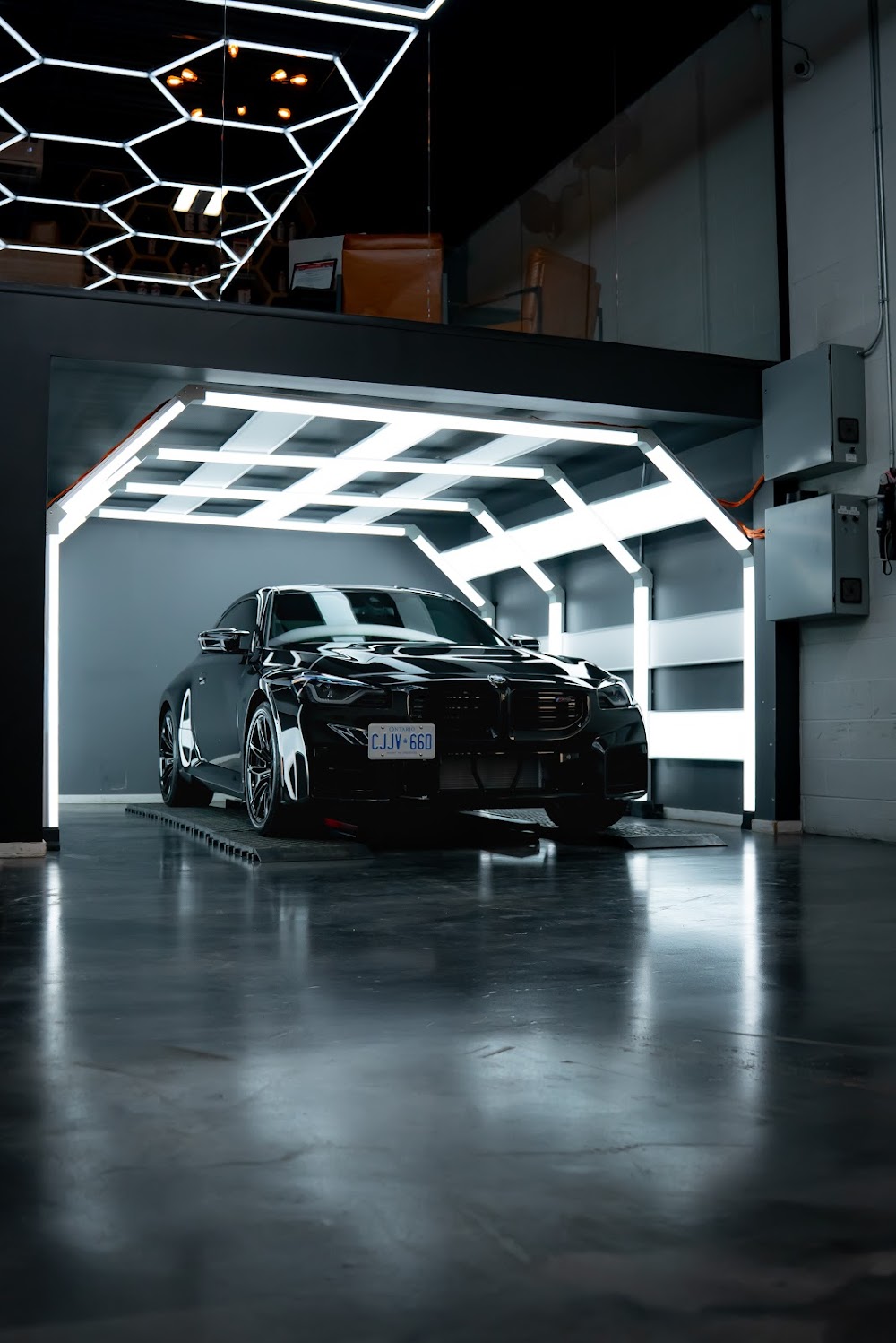 BMW M2 nose-on beneath ZAutoCare's light tunnel