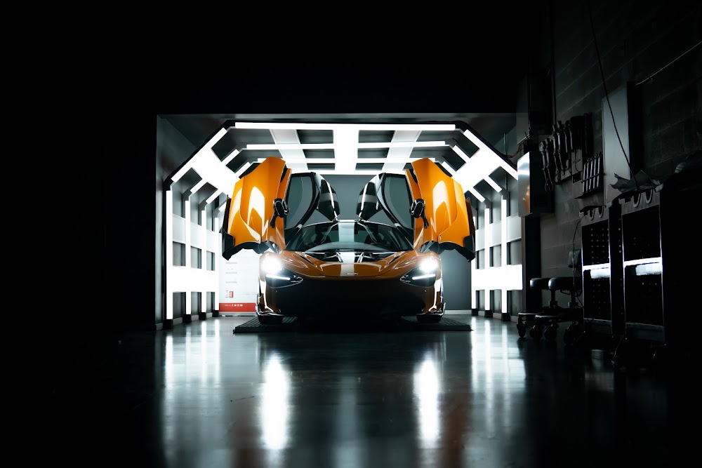 Orange McLaren 720S with doors up in the light tunnel