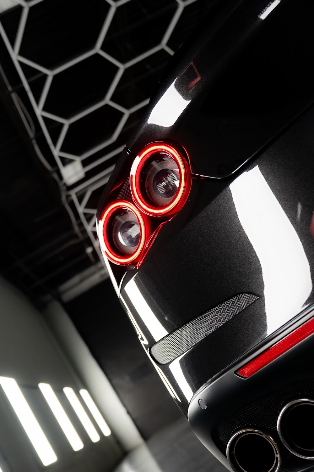 Round Ferrari taillights reflecting the hexagon lighting