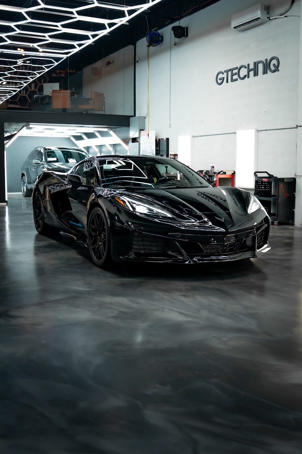 Black C8 Corvette Z06 under the light tunnel at ZAutoCare