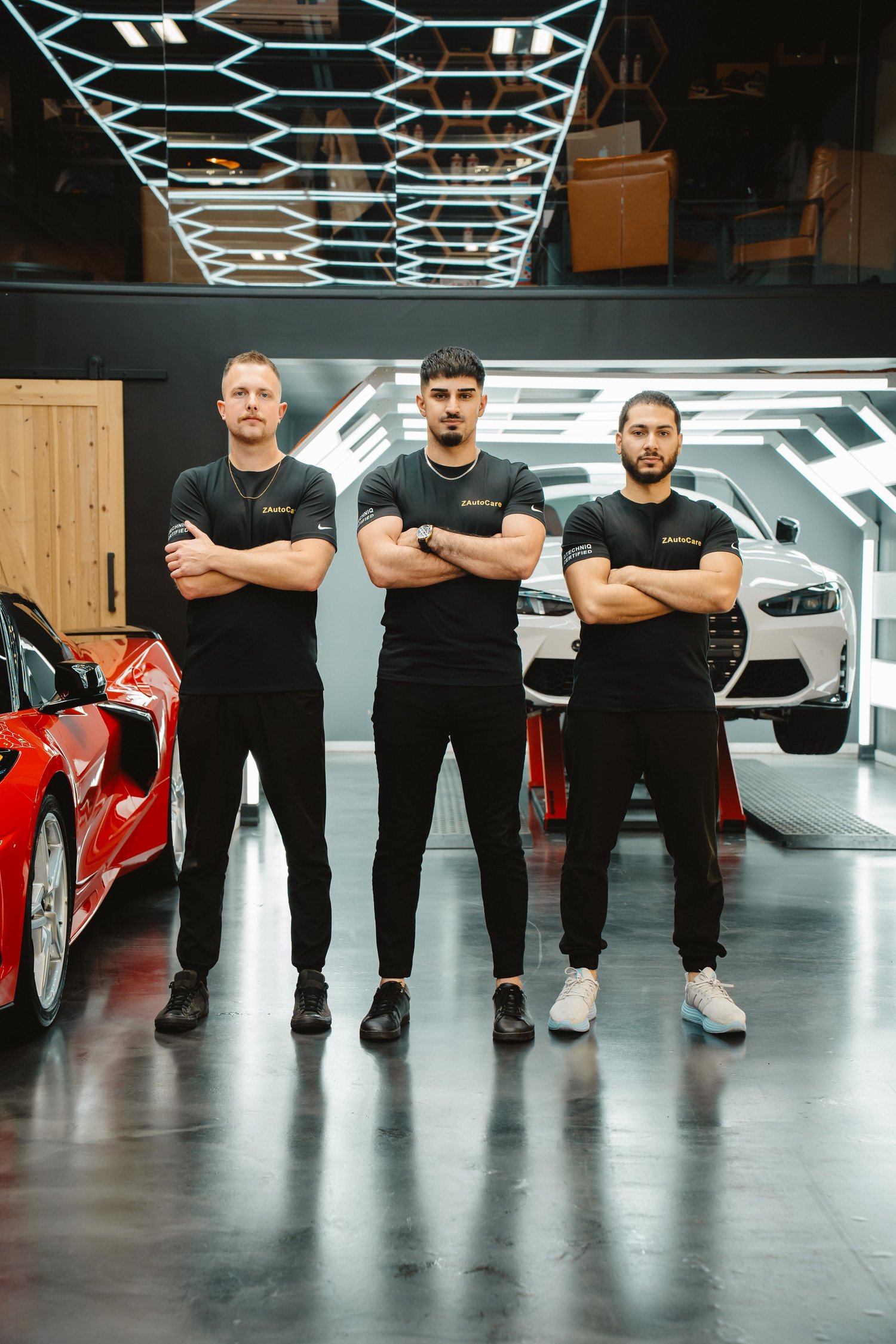 The owner and employees of ZAutoCare standing proudly inside ZAutoCare