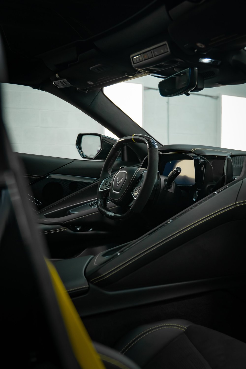 Detailed modern car interior with black and yellow stitching after a maintenance detail