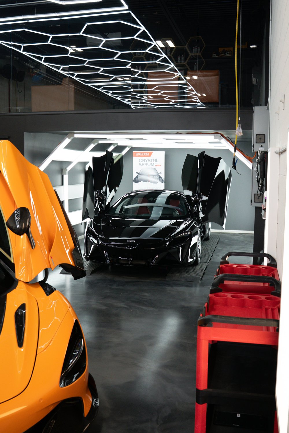 Black supercar with butterfly doors open inside ZAutoCare