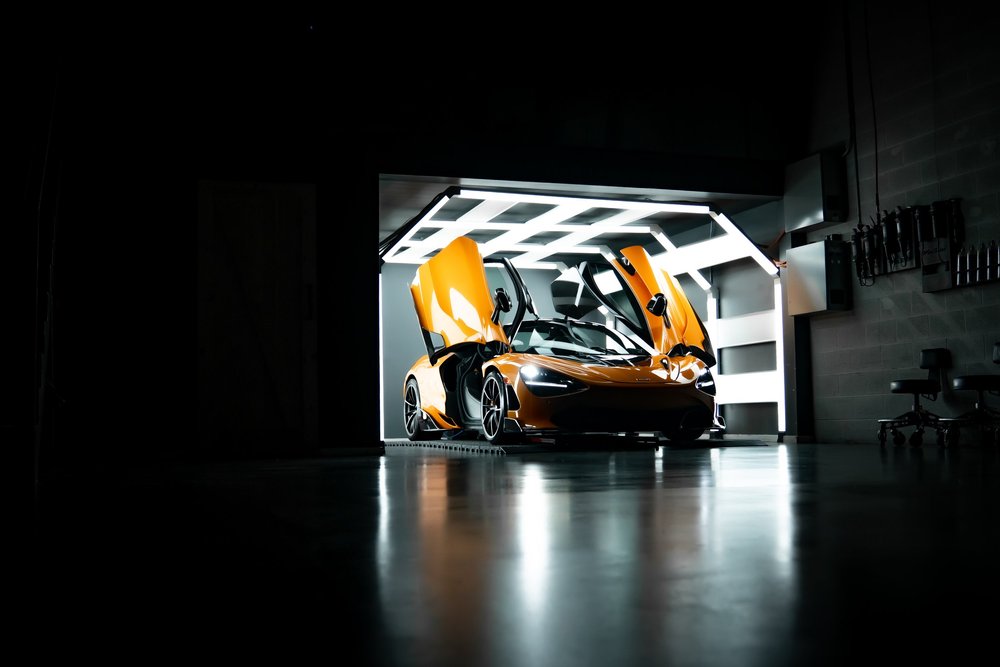 McLaren 720S in Papaya Spark with doors up after paint correction, PPF and ceramic coating