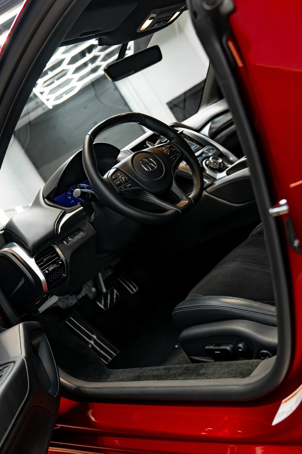 Red Acura NSX under LED lighting in ZAutoCare's detailing studio