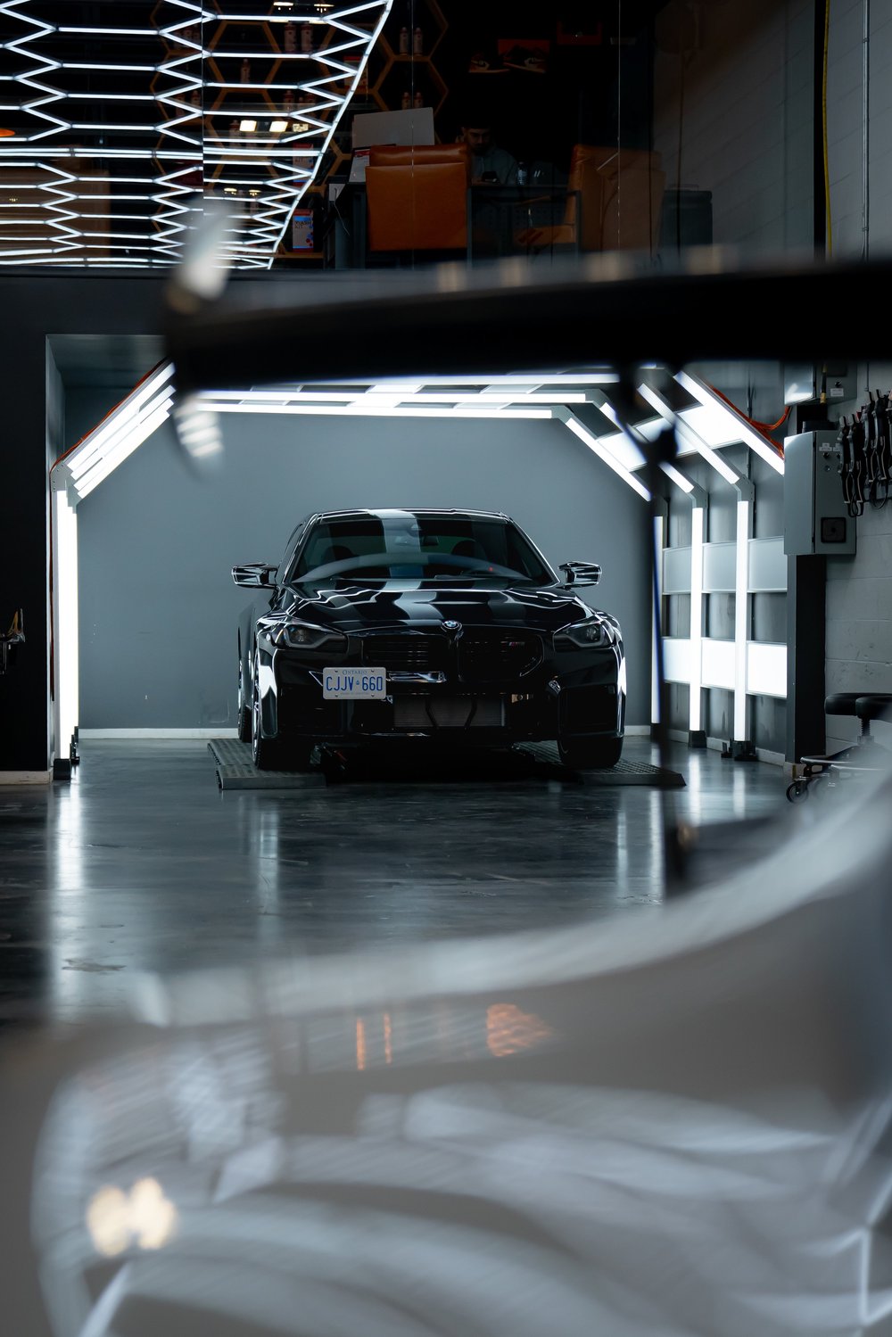 BMW M2 curing inside ZAutoCare's dedicated ceramic coating light tunnel