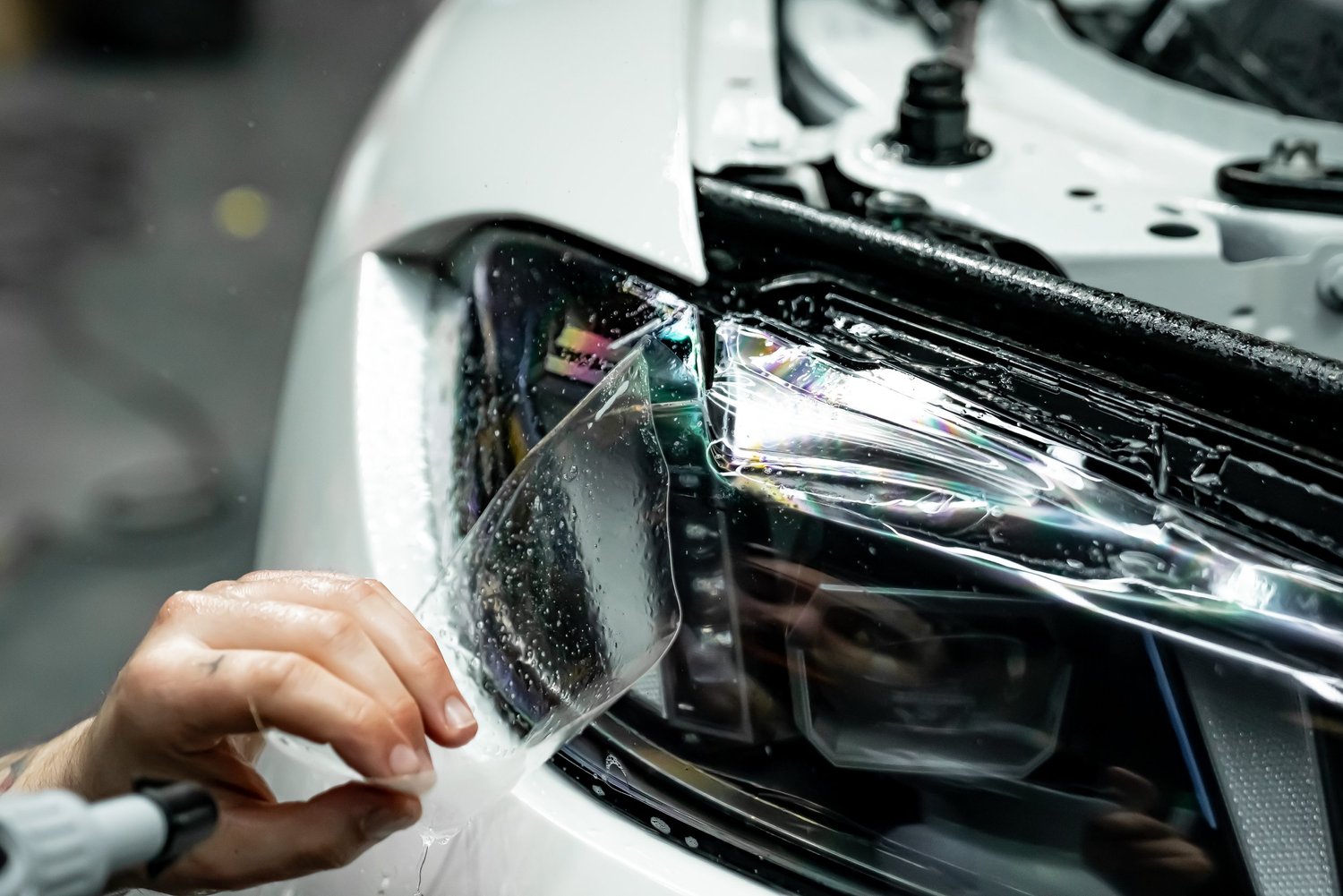 XPEL PPF being installed on a BMW M3 headlight at ZAutoCare